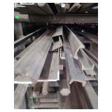 contents of shelf.  several pieces of channel steel, twisted steel, solid round steel,  round steel pipe, solid square steel. lengths range from rements to 20 feet.