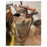 Vintage metal pump canister with hose.