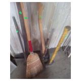 lot containing a pick axe, broom, sledge hammer, are and prooning shears, a pry bar
