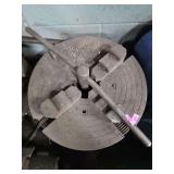 4-jaw lathe chuck, likely a piece of industrial tooling for holding irregular or round workpieces.