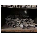 Cubby of black pipe fittings