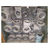 Shelf of black pipe fittings.