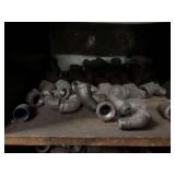 Cubby of black pipe fittings