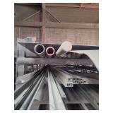 contents of shelf. several pieces of steel ranging from 4ft to 20 feet. pipe, solid round, sheet steel and flat strap.