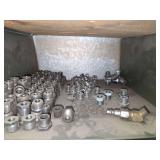 Shelf of galvanized pipe fittings.