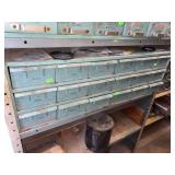 Teal storage container on shelf of various sized o rings