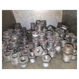 Shelf of galvanized pipe fittings