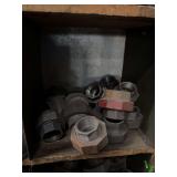 Cubby of black pipe fittings