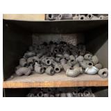 Cubby of black pipe fittings