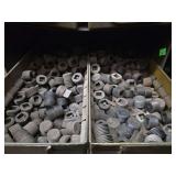 Shelf of black pipe fittings.