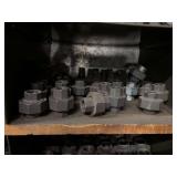 Cubby of black pipe fittings