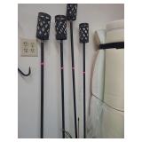 lot contains 4 TIKI Brand Urban Metal Torches, which are designed for outdoor natural flame lighting. with metal base plates