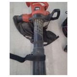 lot contains a  Black & Decker corded electric leaf blower, vacuum, and mulcher