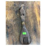 Set of wooden kitchen utensils with bird carvings.