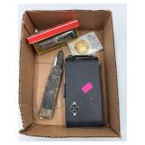 Box with camera, coin and harmonica