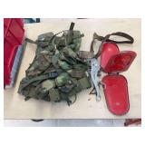 Tote with military-style web belt pack, old head stall, folding reflector, and misc items