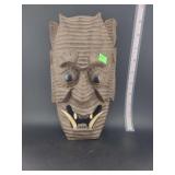 lot contains  a  hand-carved wooden mask, often identified as an Oni or Hannya-style mask. 9 inches in height.
