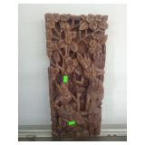lot contains a hand-carved Balinese wooden wall panel. These intricate carvings typically feature traditional Indonesian motifs and are frequently used as decorative wall art, often depicting scenes f