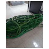 lot contains several pieces of both round and flat water hose of different lengths