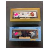 2 HO scale train cars. 1 is a Denver Broncos Super Bowl 33, and 1 is a Washington Redskins Super Bowl 17 Champions