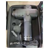 Massage gun with cas and accessories.