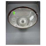 Glass serving dish with metal base and rim.