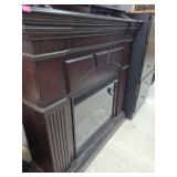 lot contains a  free-standing electric fireplace, which typically features an integrated heater and a simulated flame display for ambiance.