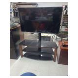 lot contains a LG 55lf600 55inch flat screen TV mounted into a black glass tv stand.