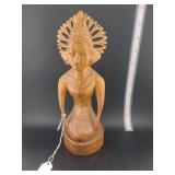 lot contains a hand-carved Balinese wooden sculpture, frequently identified as a depiction of Dewi Sri.
