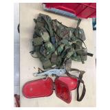 Tote with military-style web belt pack, old head stall, folding reflector, and misc items
