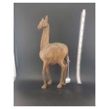 lots contains  a hand-carved wooden camelid figurine, such as a llama or alpaca.