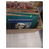 lot contains a box of vintage 78 RPM records by various artists.