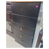 lot contains a black five-drawer dresser missing 2 knobs.