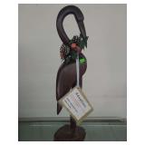 lot contains a hand-carved wooden bird sculpture, which is a decorative collectible item. 24 inches tall made from ironwood