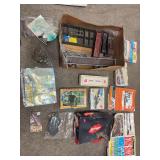 Assorted scale, train, modeling items, track plans, plan, books, scale, building, a scale, crossings, decals, trees, organizing bins, real grease, lubricant, stale tanks, rocks, etc. ￼