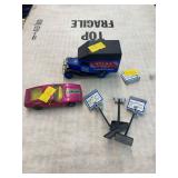 1/64 scale Atlas tires truck, matchbox car and three small drive in signs.