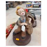 Ceramic Boy playing instrument