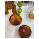 amber-colored glass decanter bottle and vintage amber coasters
