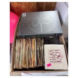 Box of mixed CDs and vinyl records