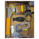 Staple gun and slap gun with staples and a hand clamp.