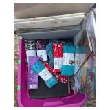 Misc fabric crafting supplies in a bin.