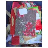 Tote of christmas bags and boxes.