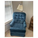 Upholstered chair and floor lamp