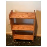 Small three tier wood shelf on wheels