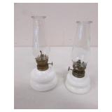 2 small white oil lamps