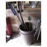 2 trash barrels & shovel & stick inside them