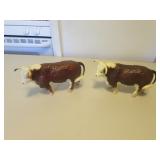 2 plastic brown cows