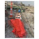 Caution fencing, cone, and a frame
