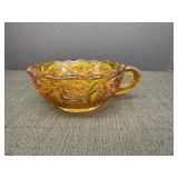 Amber glass handled nappy dish, sawtooth rim,