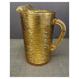 Amber glass pitcher, textured swirl design, 9in.